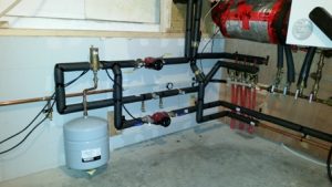 Ground loop manifold and pumps for radiant hydronic surfaces and ventilation cooling coil.